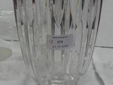 a glass vase with a label on it on a table