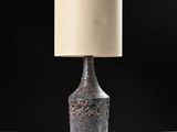 a close up of a lamp on a table with a black background