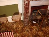 two chairs and a table in front of a fire place