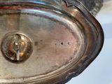 a close up of a silver plate with a cross on it