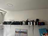 many spools of thread on a shelf in a room