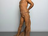 sculpture of a woman standing on a pedestal with her hands on her hips