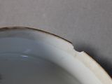 a close up of a white bowl on a table