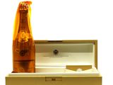 a bottle of champagne sitting in a box next to a bottle of wine
