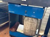an image of a blue work bench with a bag on it