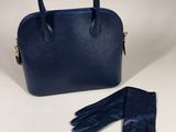 a pair of gloves and a handbag on a white background