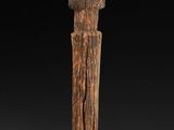 a close up of a wooden object on a black background