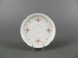 a close up of a white plate with pink flowers on it