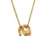a gold plated necklace with a knot on a chain