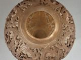 a gold vase with a floral design on it
