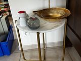 a small table with a bowl on top of it