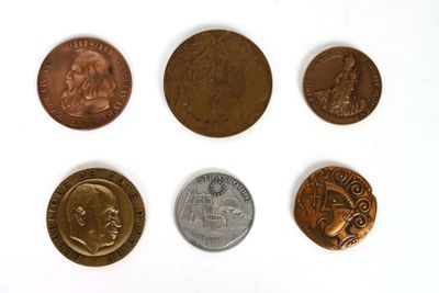 six different types of coins sitting on top of a white surface