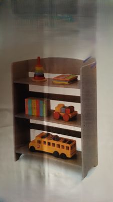 a book shelf with a toy bus and books on it