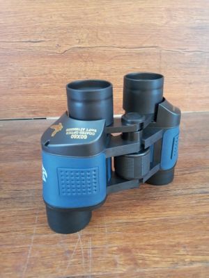 a pair of binoculars sitting on a wooden table