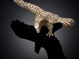 an image of a sculpture of an eagle on a black background