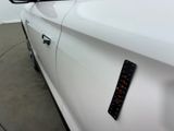 a close up of a white car with a sticker on it