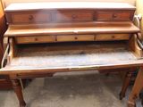 a wooden desk with a drawer on top of it