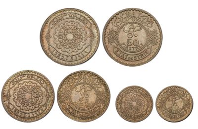 a group of five coins with designs on them