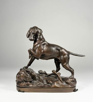 a bronze statue of a dog standing on top of a rock
