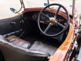 a steering wheel and dashboard of a vintage car