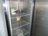 a refrigerator that is open and has a lot of food inside of it