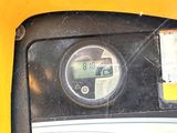 a close up of a parking meter on a yellow background
