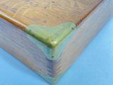 a wooden box with a handle on a blue surface