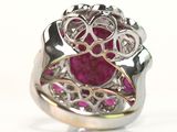 silver and gold ring with a ruby stone surrounded by pink stones