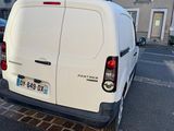 a white van that is parked on the side of the street