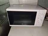 a white microwave oven sitting on a counter in a kitchen