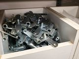 a box full of assorted metal parts in a room
