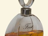 a small bottle of perfume on a white surface