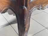 a wooden table with a drawer underneath it on a tiled floor