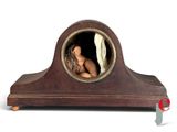 a small wooden clock with a woman in it