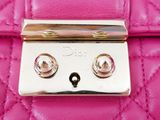 a close up of a pink purse with a lock on it
