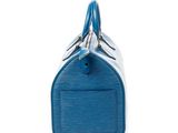 a close up of a blue bag on a white surface