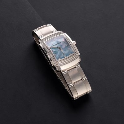 a watch that is sitting on a black surface
