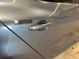 a close up of a car door handle with a sticker on it