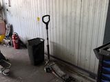 an image of a garage with tools and a trash can