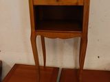 two wooden tables with a shelf on top of them