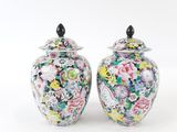 pair of chinese vases decorated with flowers and birds on a white background
