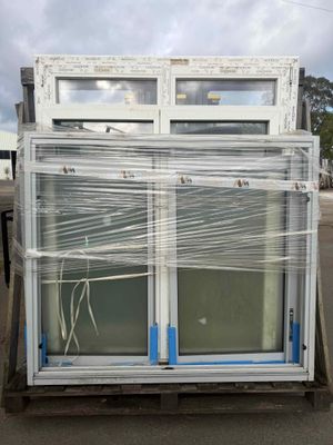 two windows that are wrapped in plastic on the back of a truck