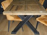 a wooden table with chairs around it in a room