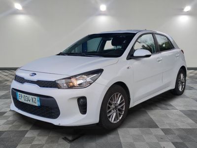 a white car is parked in a room with a checkered floor