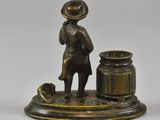 bronze figurine of a man with a pot and a dog