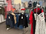 a lot of clothes on a rack in a store