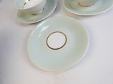 three cups and saucers sitting on a white table