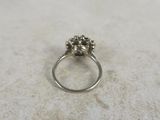a close up of a ring with a flower on it