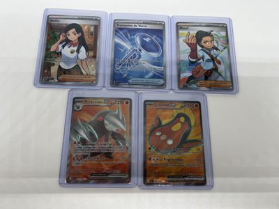 four different pokemon trading cards in plastic cases on a white surface