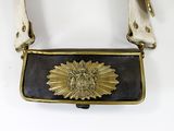 a black and gold purse with a gold sun on it
